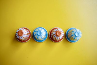 Directly above shot of multi colored candies on yellow background