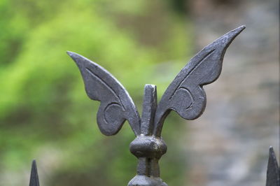 Close-up of bird sculpture on cemetery