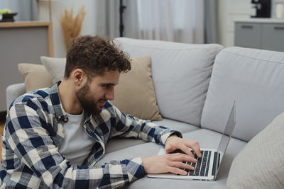 Young woman using laptop at home