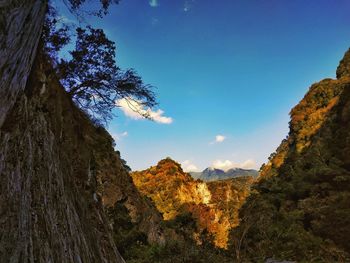 Scenic view of rocky mountains against blue sky