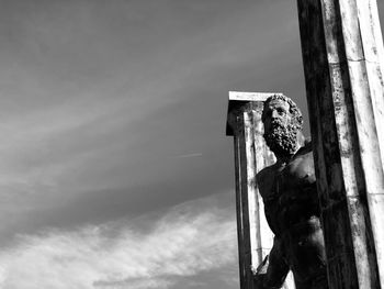 Close-up of old wooden post against sky