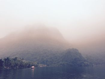 Scenic view of lake in foggy weather