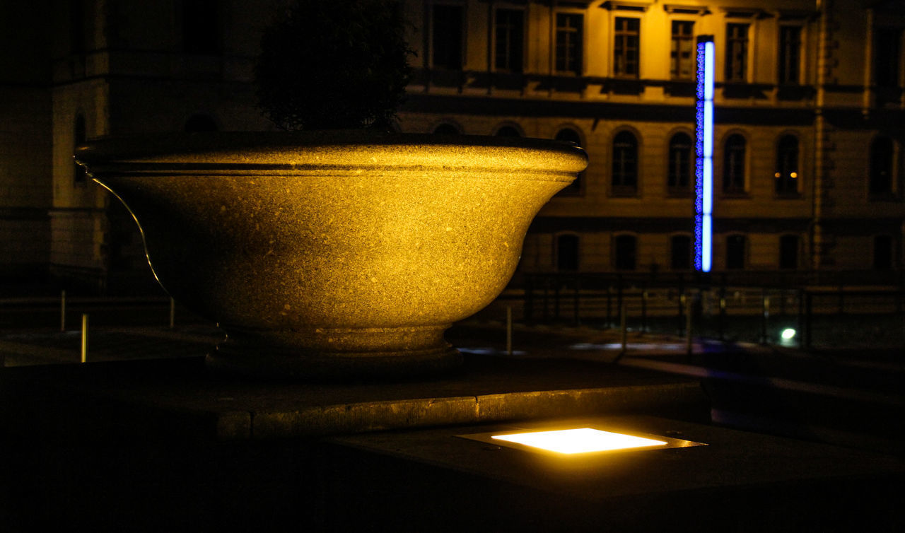 CLOSE-UP OF ILLUMINATED YELLOW LIGHT ON TABLE