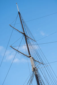 Low angle view of sailboat against blue sky