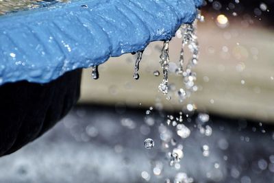Close-up of water drop falling on rainy season