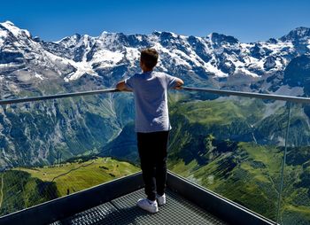 Rear view of man standing on mountain