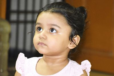 Portrait of cute girl looking away at home