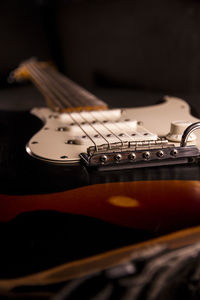 Close-up of guitar against black background