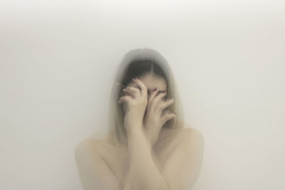 Digital composite image of woman amidst smoke against white background