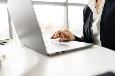 Midsection of businessman working on table