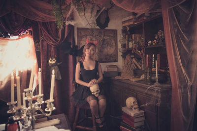 Portrait of young woman sitting in traditional clothing