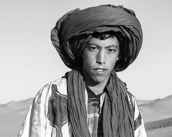 Portrait of man at sahara desert against clear sky during sunny day
