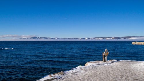 Scenic view of sea against blue sky