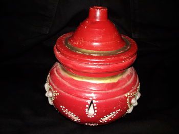 High angle view of red wine on table against black background