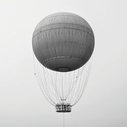 Low angle view of hot air balloon flying against clear sky