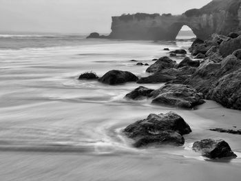 Lighthouse beach, santa cruz, coastline, black and white, foggy, rocky archway 