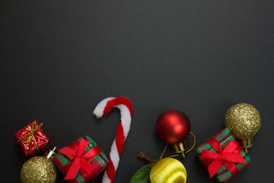 Close-up of christmas decoration on table against black background