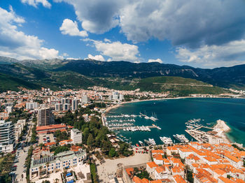 High angle view of townscape by sea against sky