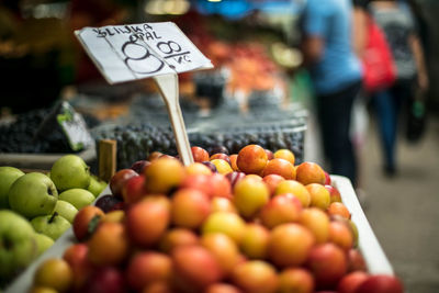 Close-up of red plums on stall at market for sale