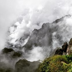 Scenic view of waterfall against sky