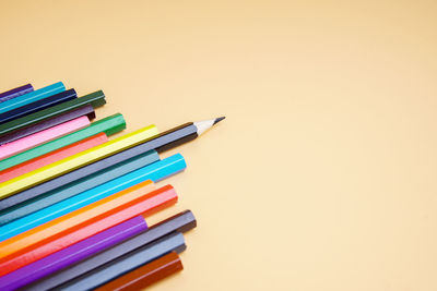 Stack of multi colored pencils on table