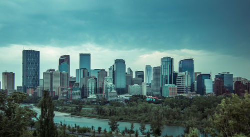 View of skyscrapers against cloudy sky