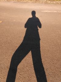 Shadow of man on silhouette person standing in park