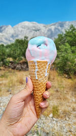 Cropped hand holding ice cream cone