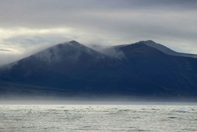 Scenic view of mountains against sky during winter