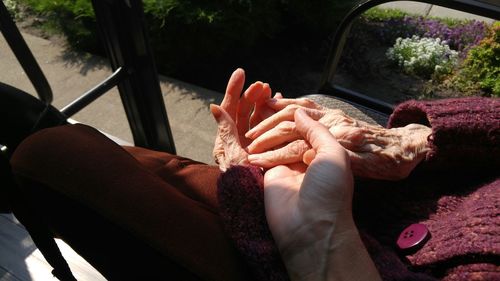 High angle view of woman hand on display