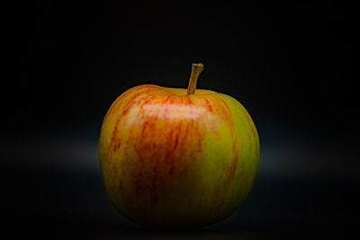 Close-up of apple against black background