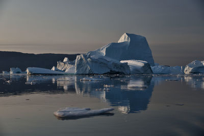 Boats in sea against sky during winter