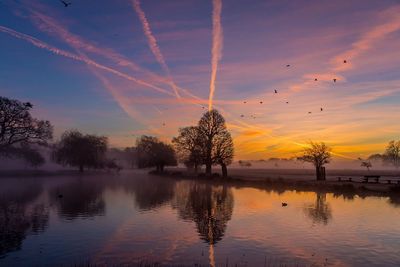 Scenic view of lake against sky during sunset