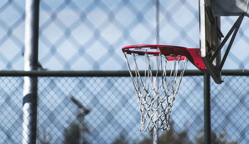 Close-up of basketball hoop against sky