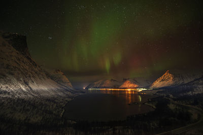 Scenic view of illuminated mountains against sky at night