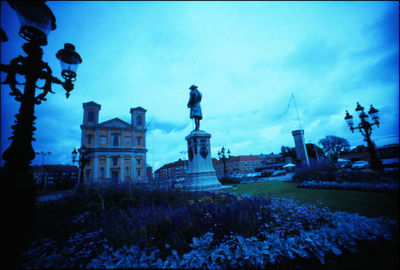 Low angle view of statue against blue sky