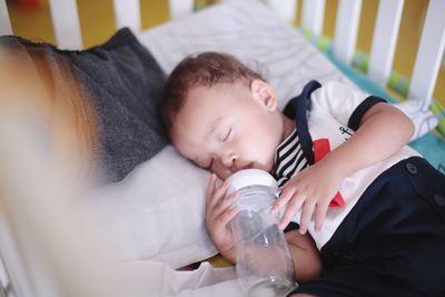 Boy sleeping on bed