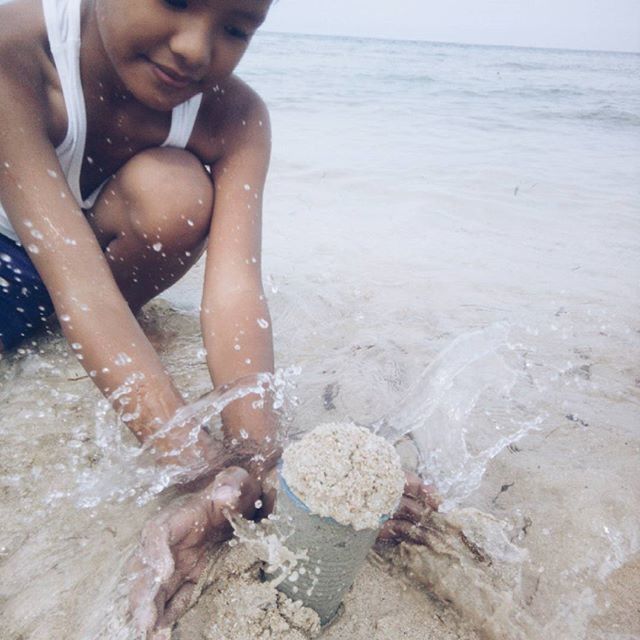 water, beach, sea, lifestyles, leisure activity, shore, vacations, sand, standing, person, barefoot, wave, shirtless, nature, day, rock - object, horizon over water