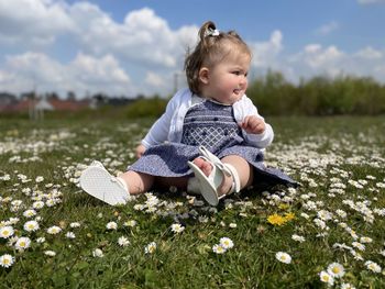 Cute girl sitting on field