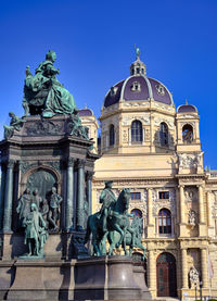 Low angle view of statue against blue sky