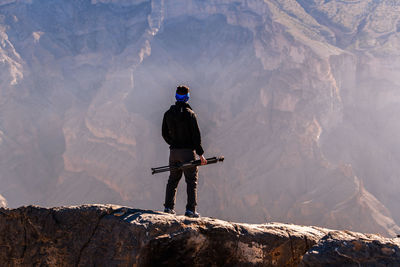 Man standing on rock in mountains