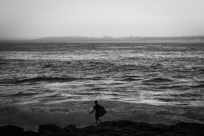 Man looking at sea against sky