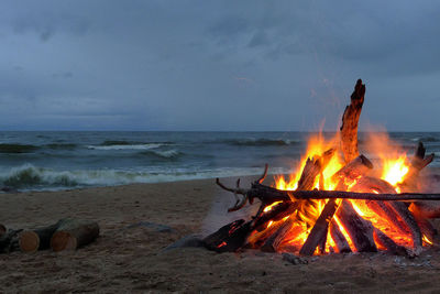 Bonfire on beach against sky