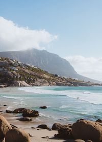 Scenic view of sea and mountains against sky