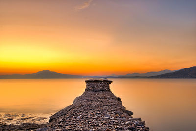 Scenic view of lake against sky during sunset