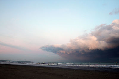 Scenic view of beach against sky during sunset