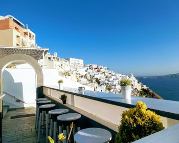 Exterior of building by sea against clear blue sky