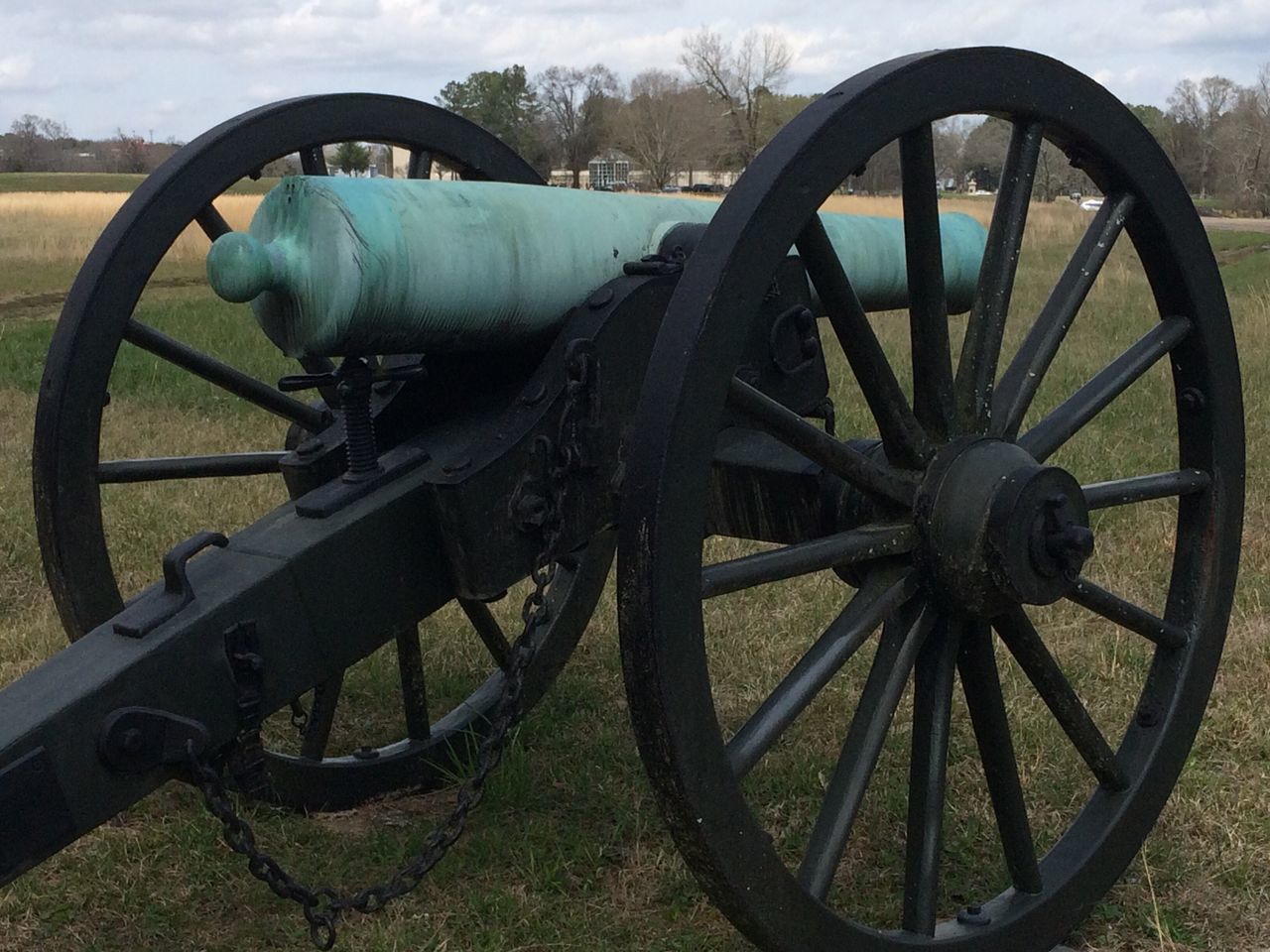 CLOSE-UP OF OLD WHEEL ON FIELD