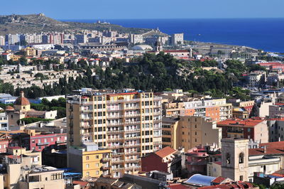 High angle view of townscape by sea against sky