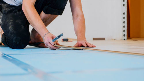 Low section of carpenter working at workshop